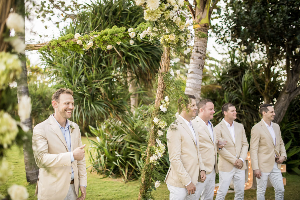 The groom starts a big smile when waiting for the bride.