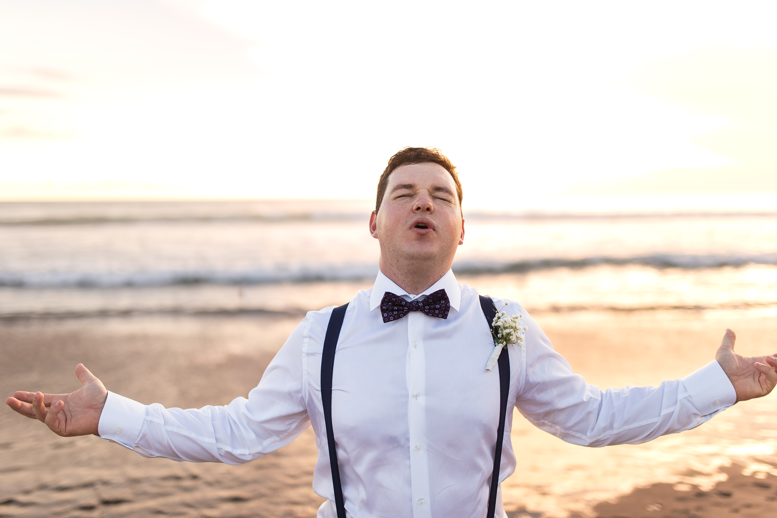 Alila Seminyak Wedding - Fun groom portrait on the beach