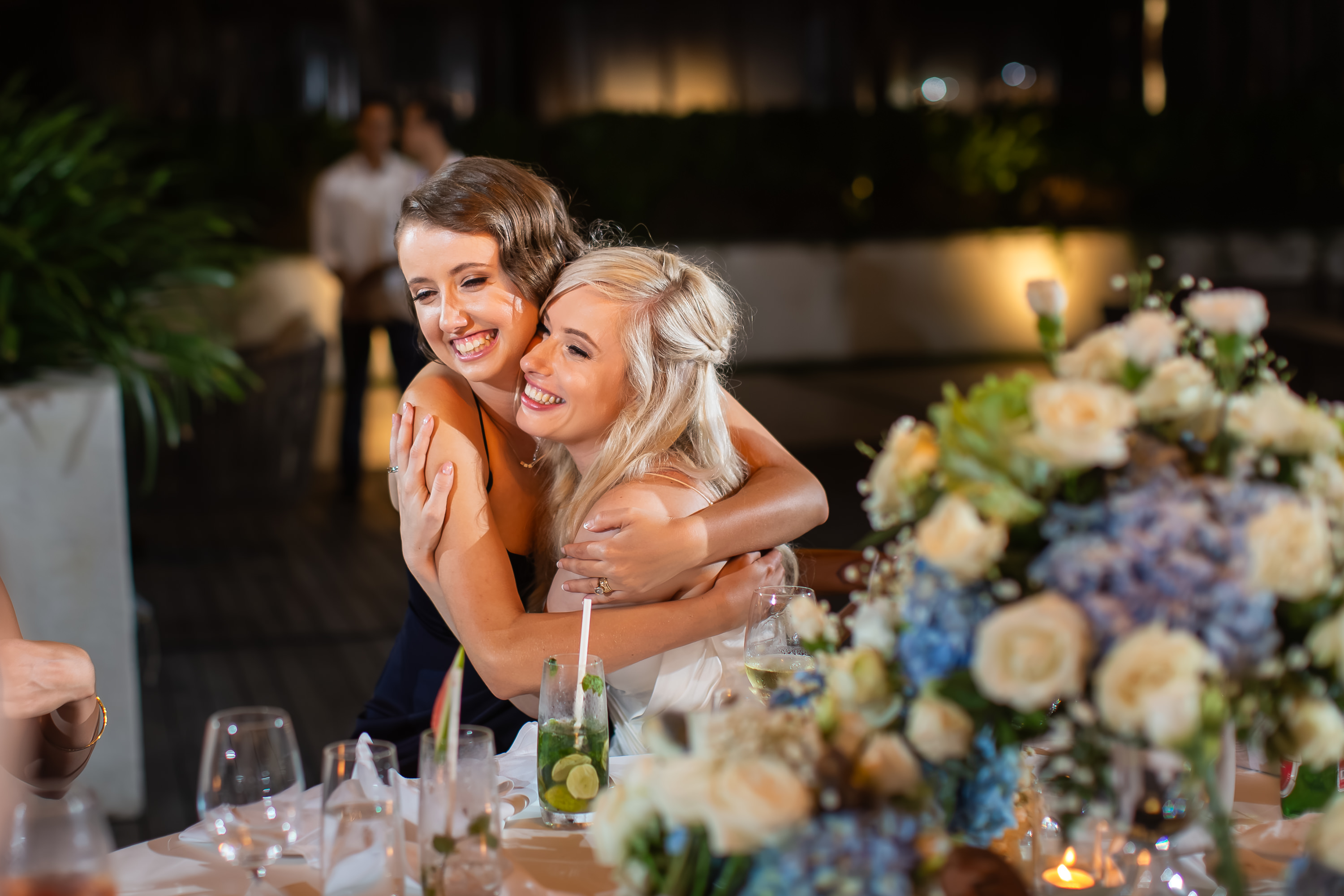 Alila Seminyak Wedding - Bride hugging a guest at the reception