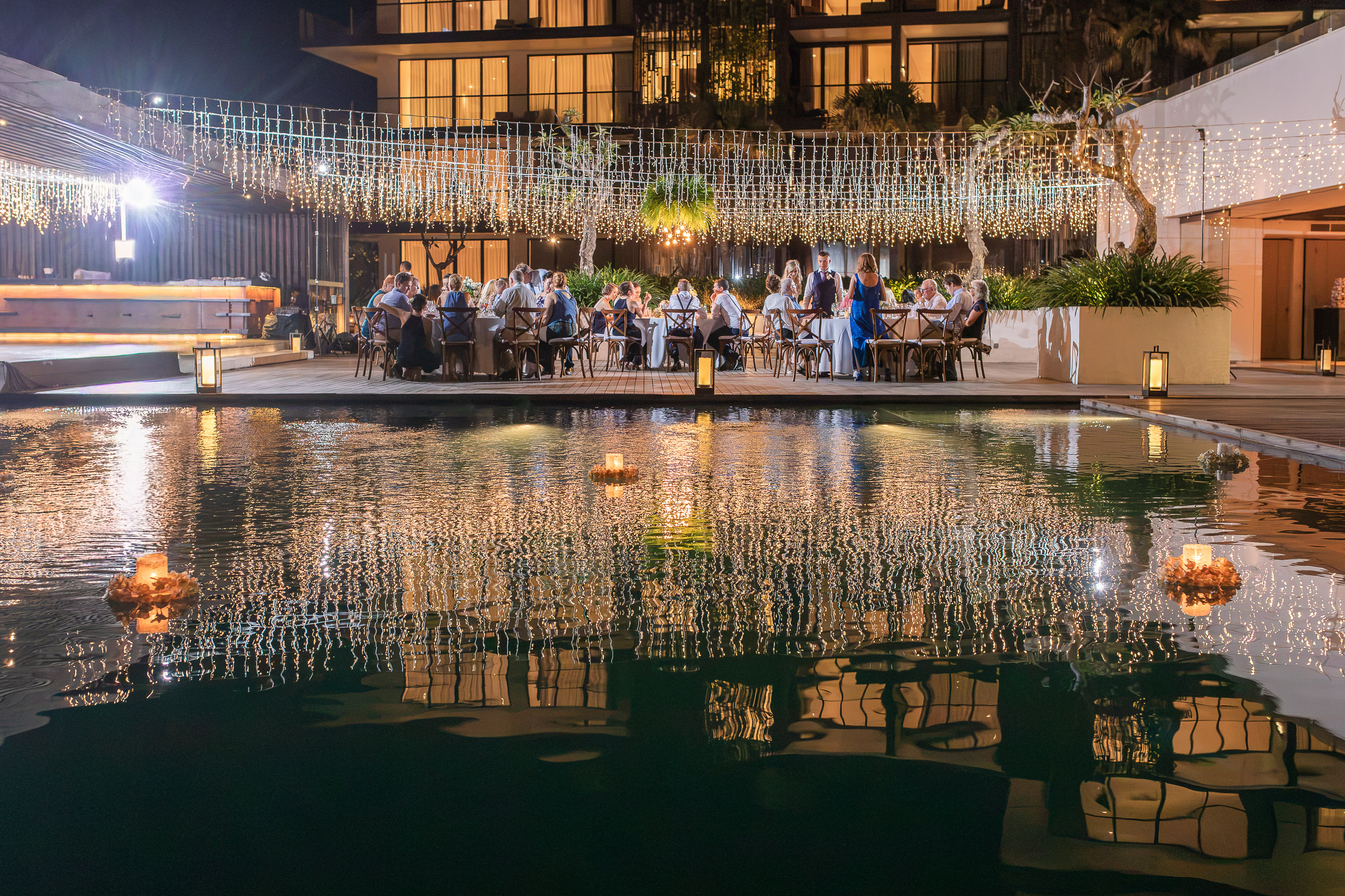 Alila Seminyak Wedding - Poolside wedding reception at night
